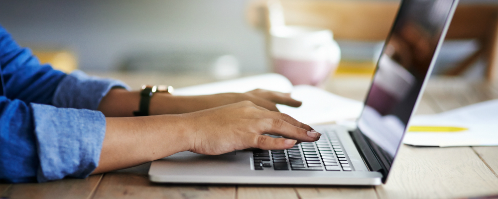 person typing on laptop