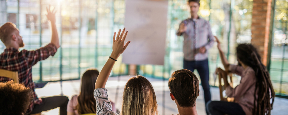 small group of students asking question in classroom 